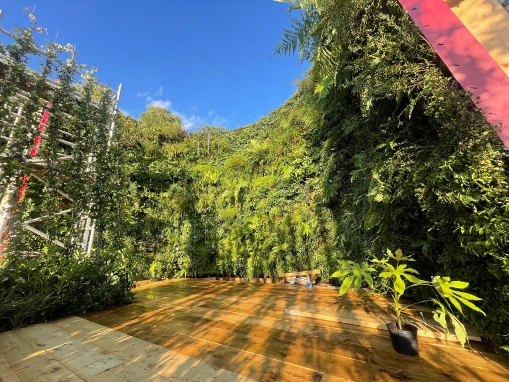 Life on Walls green wall installation at RHS Hampton Court Palace Garden Festival, showcasing a lush vertical garden in full sunlight