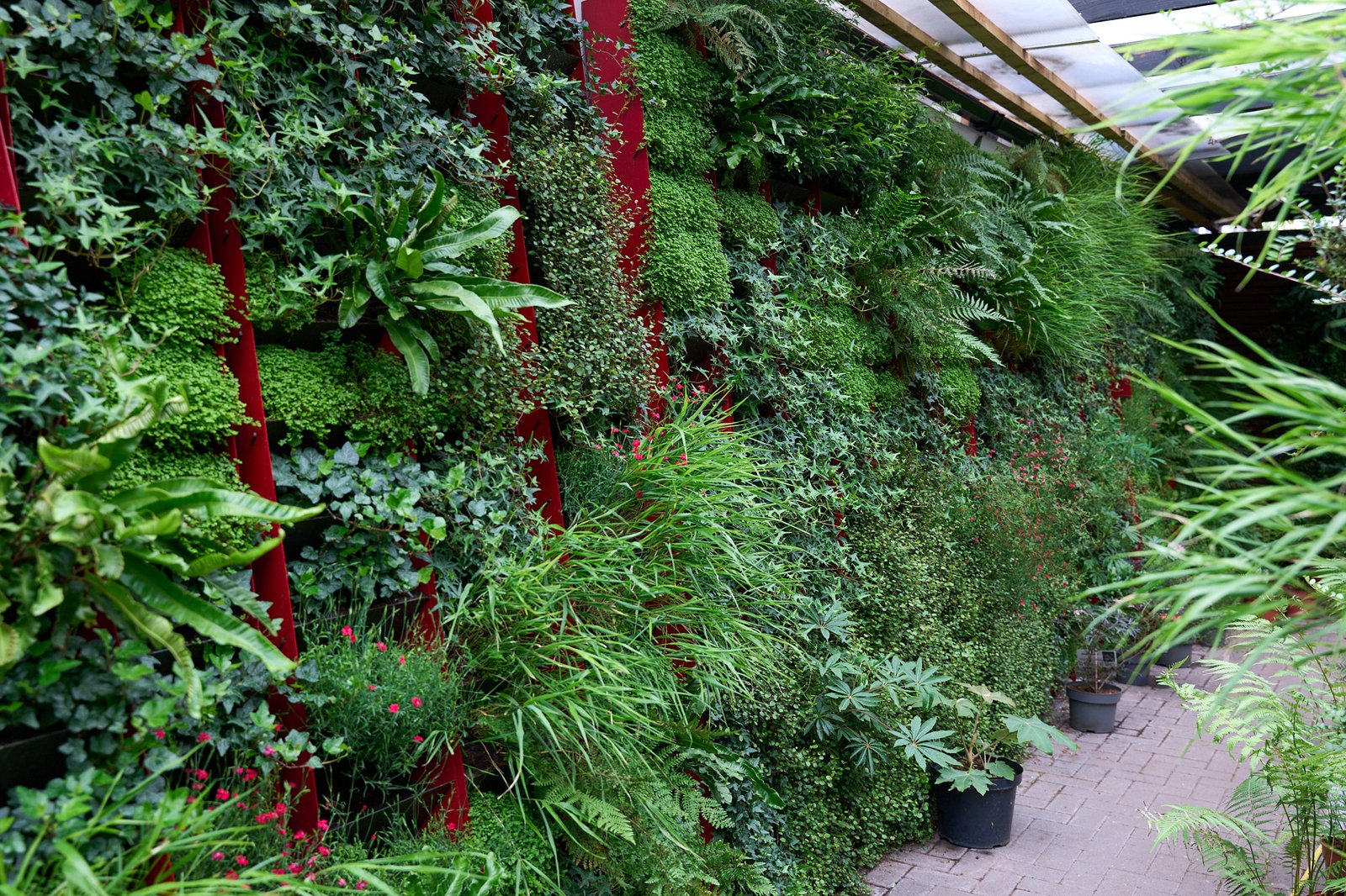 Vertical garden exhibit at RHS Hampton Court with visitors