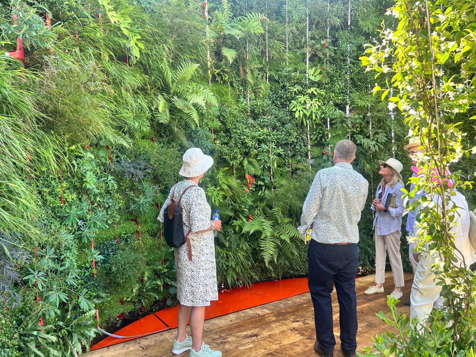 Visitors in front of the RHS Hampton Court vertical garden